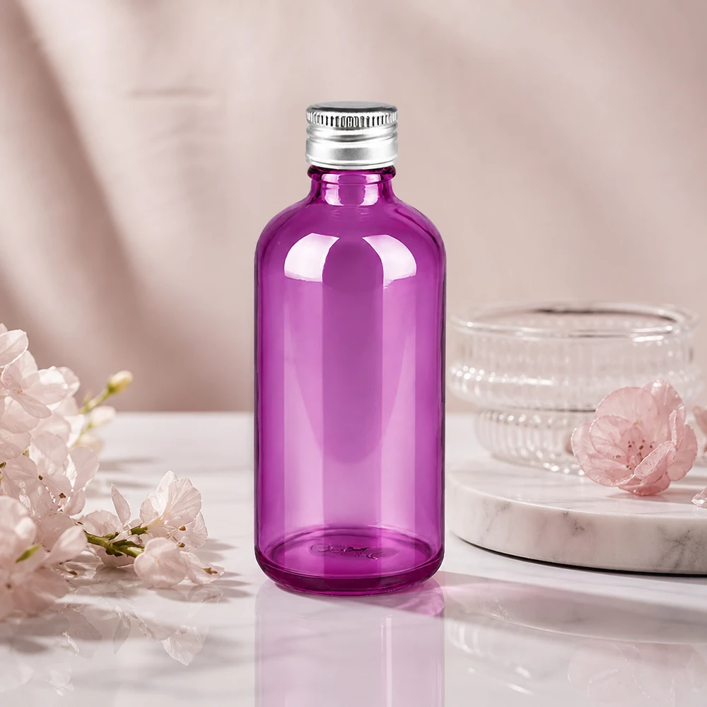 Tyylikäs pyöreä 100 ml:n lasipullo, violetti, jossa on kapea 11 mm:n kaula tarkkaa annostelua varten.