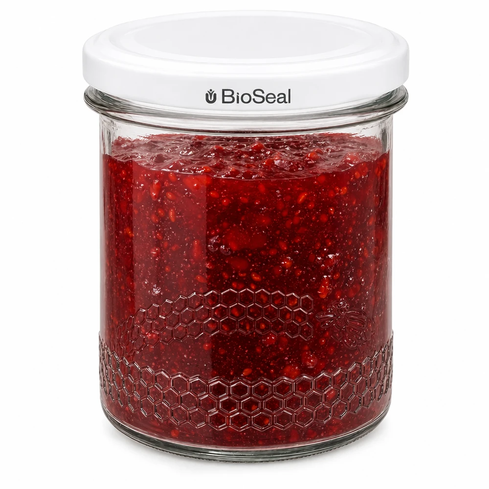 BioSeal-säilöntäpurkki 400ml täynnä punaista hilloa, jossa on ilmatiivis tiiviste ja hunajakennopainatus purkin reunalla.