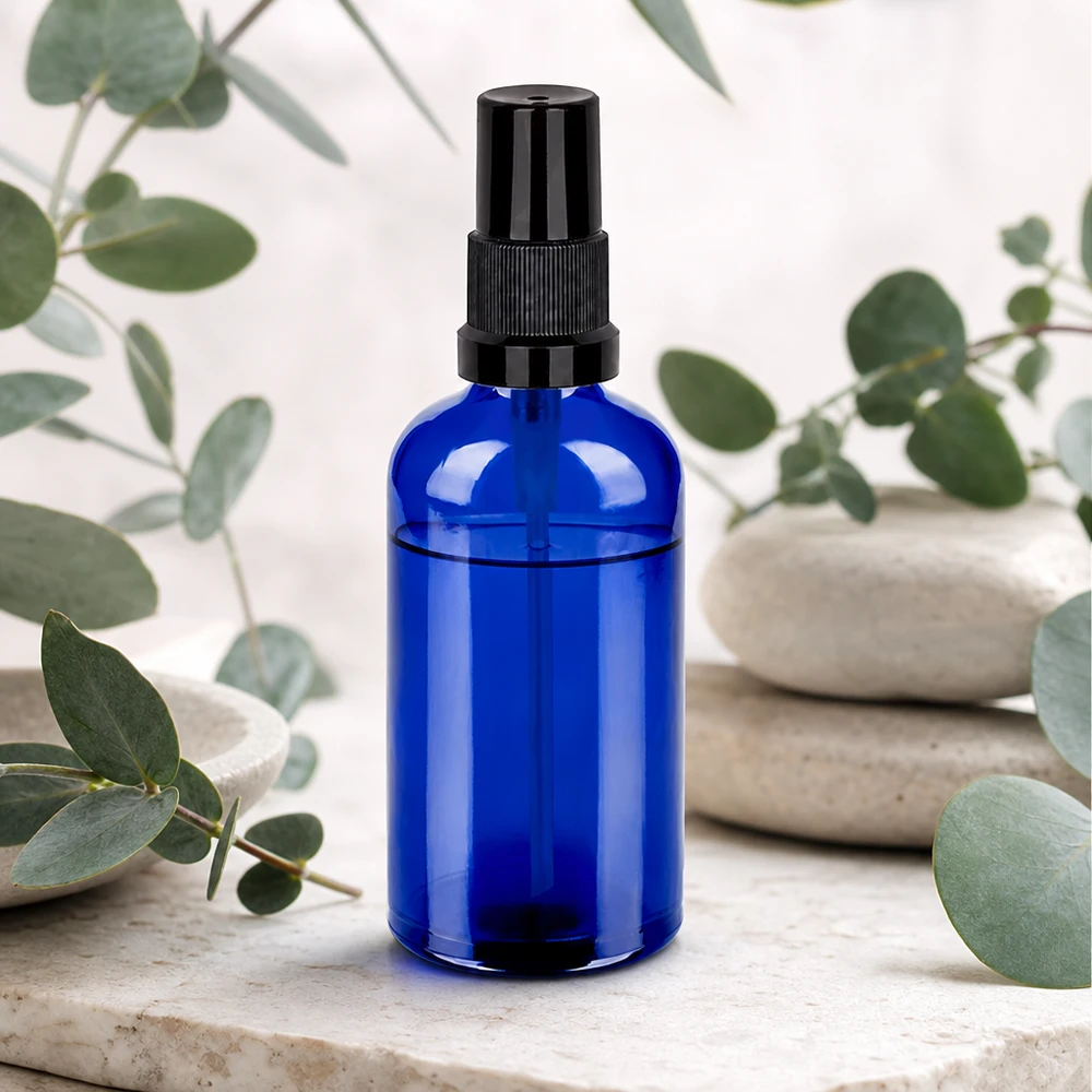 100ml sininen lasipullo suihkutuslisäosalla - kompakti koko matkoille ja liikkeellä oloon.