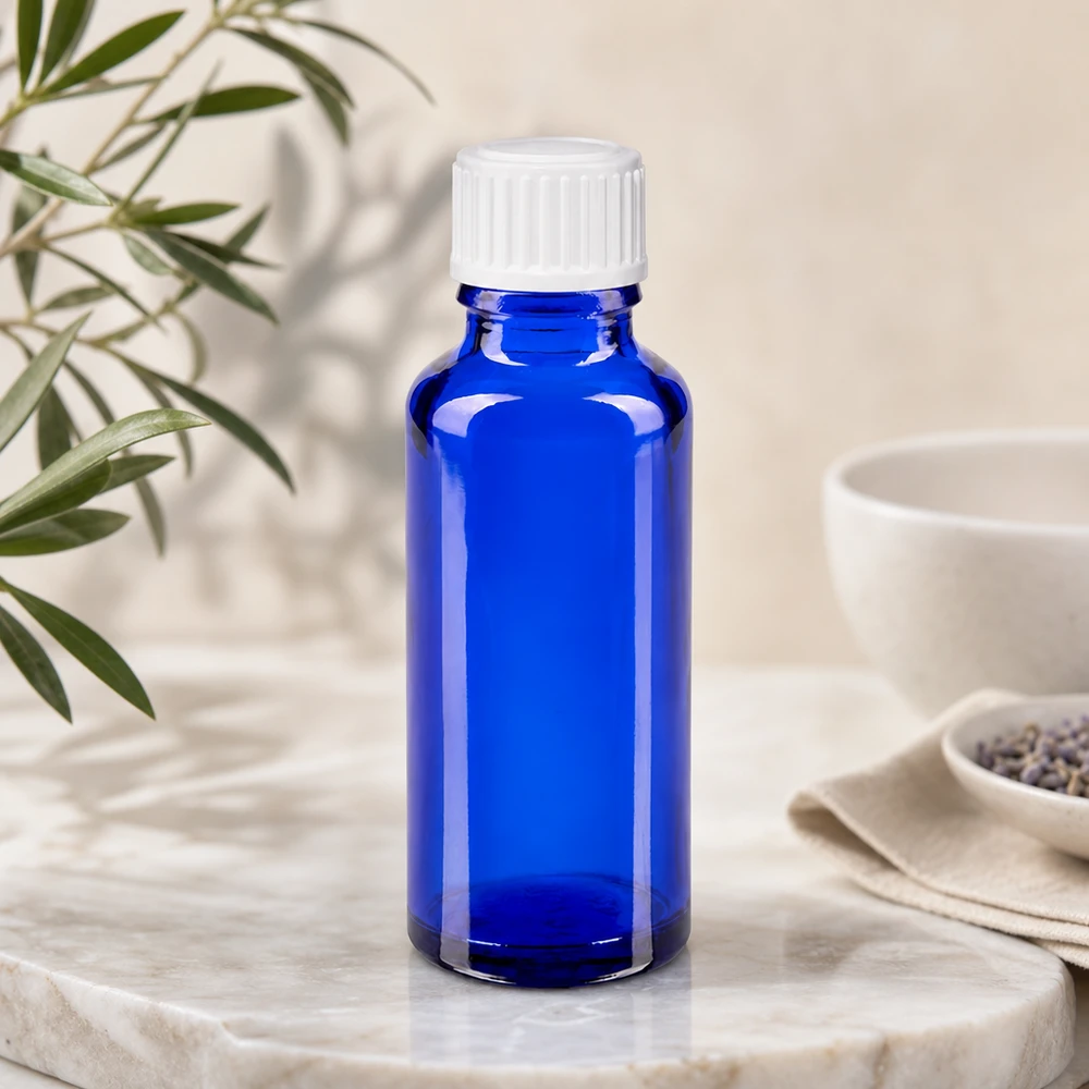 Sylinterimäinen 30 ml:n apteekkipullo, koboltinsininen, valkoisella vakiokorkilla (11 mm)