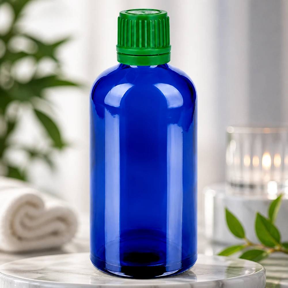 100ml pullo 11mm kierrekorkki vihreä väärentämisen estävä korkki BlueLine UT18/100 Kompakti 100 ml:n lasipullo, sininen, vihreä korkki tarkkaa annostelua ja turvallista säilytystä varten.