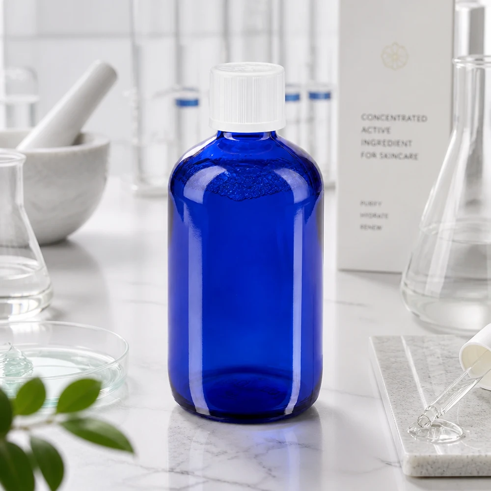 Apteekkipullo sininen 100ml tippakorkki valkoinen lapsiturvallisuusstandardi Koboltinsininen 100 ml:n apteekkipullo, jossa on valkoinen kierrekorkki, laboratoriossa marmorialustalla